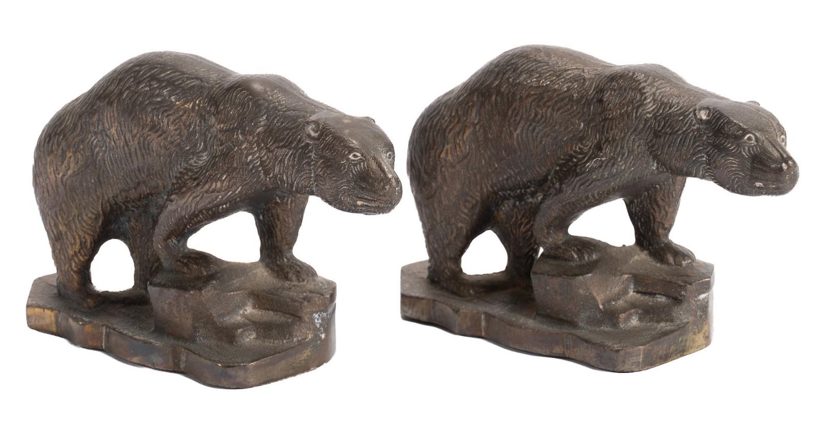 A pair of vintage iron bookends, each in the figure of a bear standing on an uneven stone ground. Estimate $200-$400