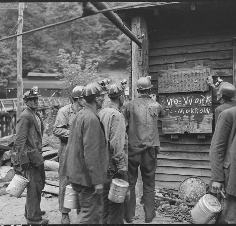 Miners bring in their checks and see the sign that there is no Saturday work. P V & K Coal Company, Clover Gap Mine, Lejunior, Harlan County, Kentucky.